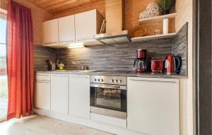 a kitchen with white cabinets and a stove at Lovely Home In Olbernhau With Wifi in Pfaffroda