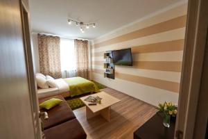 a hotel room with a bed and a couch at PaulMarie Apartments on Mira 25B in Mogilev