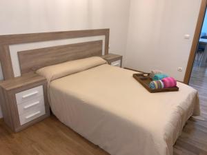 a bed with a tray with a stuffed animal on it at New, cozy apartment Plaza del Pilar-Fuenclara in Zaragoza