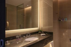 a bathroom with a sink and a mirror at Views Hotel & Residences in King Abdullah Economic City