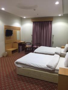 En eller flere senge i et værelse på Kol Alayam Hotel