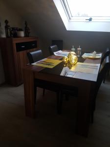 a dining room table with a lamp on it at Monteurwohnung Schinderhannes in Miehlen +33 photos