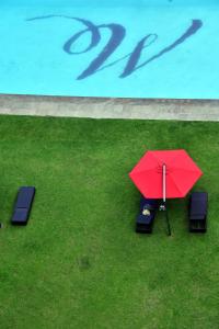 an overhead view of a red umbrella and two chairs at WeStay Westpoint Apartments in Johannesburg