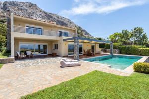 a villa with a swimming pool and a house at Amazing 5 bedroom Villa with Swimming Pool in Athens