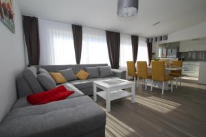 a living room with a couch and a table at Luxury apartment Navi in Podstrana