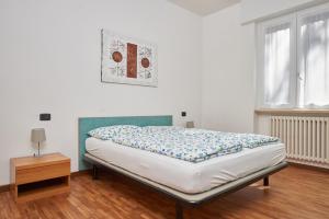 a bed in a room with a wooden floor at Casa Manu in Brenzone sul Garda