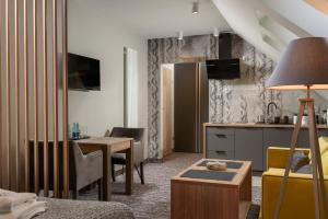 a living room with a kitchen and a dining room at Apartamenty Pulower z klimatyzacją - Dream Apart in Szczyrk