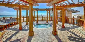 a covered deck with a hot tub on the beach at Just Updated - Beachfront Ocean view, 19th Floor in Destin