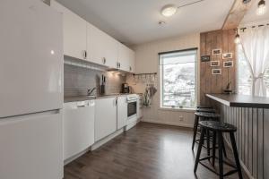 a kitchen with white cabinets and a counter at SAGI 4 PRIVATE APARTMENT in Hafslo