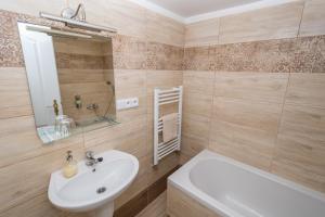 a bathroom with a sink, toilet and bathtub at Apartment Belveder Brno in Brno