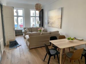 a living room with a couch and a table at Royal Residence in Lübeck