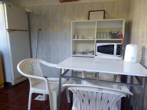 a white table with two chairs and a microwave at Habitaciones con Baño Privado Economicas in La Serena +16 photos