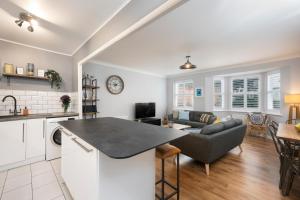 a kitchen and living room with a couch and a table at Burlington Street with free parking Nr Brighton College and Hospital in Brighton & Hove