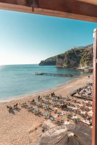 a beach with a bunch of umbrellas and the ocean at R club Apartments Old Town Budva in Budva