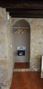 a stone wall with a stove in a room at AL - HaoleGuestHouse in Sobral de Monte Agraço