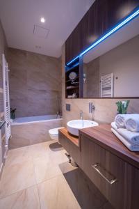 a bathroom with a sink and a mirror and a tub at Villa Meribel in Tatranská Lomnica +40 photos