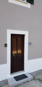 a door in a white building with a mat in front of it at AL - HaoleGuestHouse in Sobral de Monte Agraço