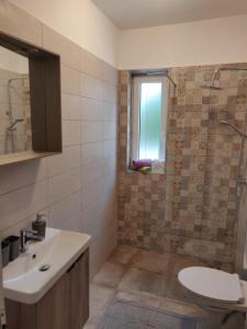 a bathroom with a toilet and a sink and a shower at Apartment Lidija in Krk +19 photos