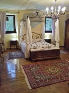a bedroom with a bed and a chandelier at Villa Della Stua in Cormòns
