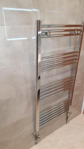 a stainless steel refrigerator in a room at Islington Apartments in London