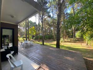 una gran terraza con sillas, mesas y árboles en Pinos De Mar, en Costa del Este