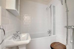 a bathroom with a sink and a tub and a toilet at Pannett View - in the heart of Whitby in Whitby