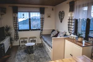 a bedroom with a bed in a room with windows at Horská Chata U Kameníčka in Jáchymov