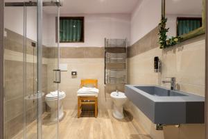 a bathroom with a sink and a toilet at Locanda San Giorgio in Sestola