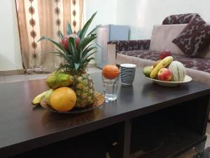 a table with two bowls of fruit on it at IMMEUBLE KCF in Bamako