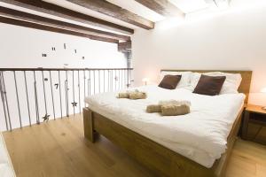 een slaapkamer met een groot wit bed met 2 kussens bij Sweet getaway loft - new, central & parking in Ljubljana