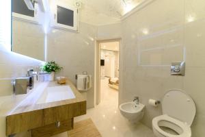a white bathroom with a toilet and a sink at Luxury Apartment Salerno Center in Salerno