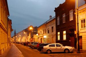 a row of cars parked on a street at night at FLEXIHOME sk - Design City - top Location close city centre - big squared in Košice