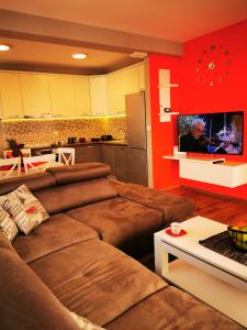 a living room with a couch and a kitchen at Mia apartment in Bar