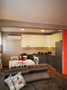 a living room with a couch and a kitchen at Mia apartment in Bar