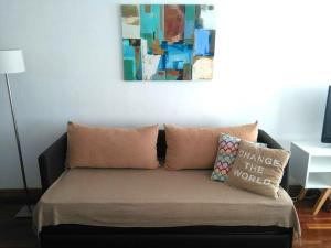 a couch with pillows on it in a living room at M & C Suites in Buenos Aires