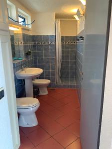 łazienka z 2 toaletami i umywalką w obiekcie Ferienhaus Panorama, San Teodoro, Isuledda w mieście San Teodoro