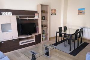 a living room with a glass table and a television at BONITO ALOJAMIENTO EN BRIONES in Briones