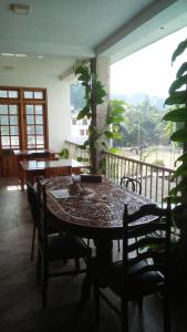a table and chairs in a room with a balcony at Old Town Hotel in Kandy