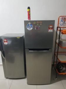 two refrigerators are sitting next to each other at langkawi homestay murah empat bilik in Kuah