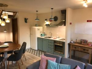 a kitchen with a table and a kitchen with a refrigerator at Studio Rural in Vilarinho