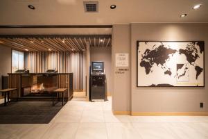 a room with a world map on the wall at Super Hotel Ishikari in Ishikari