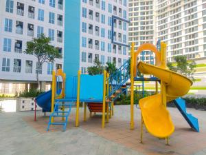 a playground with a blue and yellow slide at Modern and Comfy Studio Apartment Grand Dhika City By Travelio in Bekasi