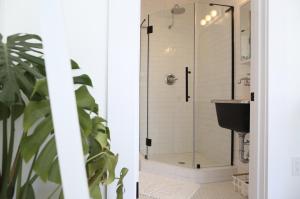 a bathroom with a glass shower with a sink at The Burlington in Los Angeles +64 photos