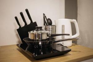 a kitchen counter with a coffee pot and utensils at P1 Silom Pan large room full kitchen WIFI 4-6pax in Bangkok