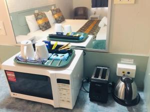 a microwave sitting on a counter in a room at Emerald Highlands Motel in Emerald