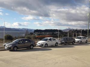 a group of cars parked in a parking lot at Las Victorias 3 in San Carlos de Bariloche