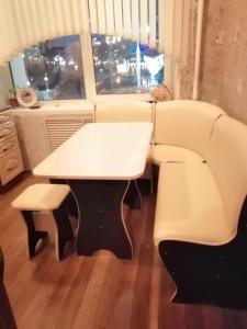 a couch and a table and a table and chairs at Апартаменты в самом центре Витебска in Vitebsk