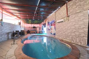 a swimming pool in a room with a brick wall at OYO 367 Eureka Hotel in Dubai