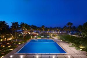 a view of the pool at night at Estuary Sarovar Premiere Poovar Island in Pūvār