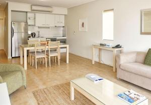 a living room with a couch and a table at Nesuto Geraldton in Geraldton